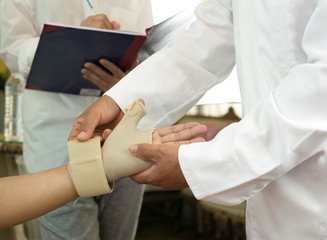 Doctor bandaging  patient is hand injuries