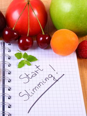 Fruits and vegetables with notebook, slimming and healthy food