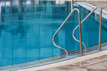 Metal handhold entrance to the blue hotel pool