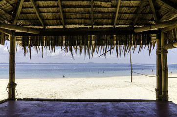 beautiful tropical beach with white sandy beach from bamboo hut. beach volley ball net on background.