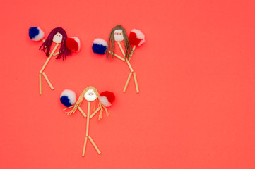 Cheerleader button head stick figures with blue and red  pompoms 