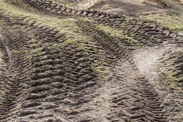 Curved tractor tracks in the mud