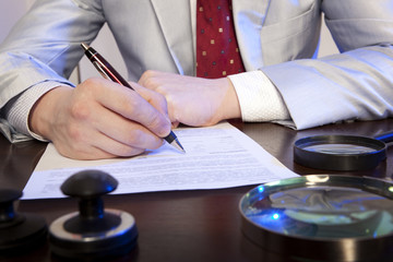 Notary signs the documents from our office