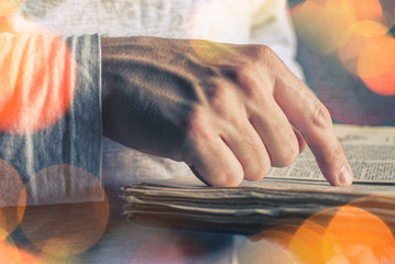 Man reading old book with torn pages