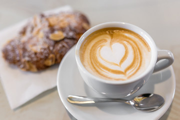 Italian cappuccino with fresh almond cornetti