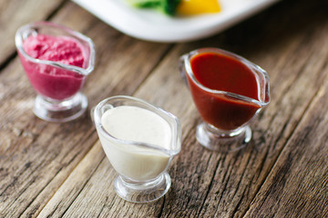 European cuisine.  The variety of sauces: mayonnaise, tomato, horseradish.  Top view on european cuisine  food on wooden background.