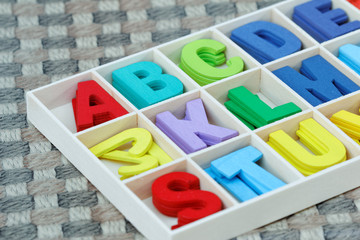 Colourful wooden alphabet block.
