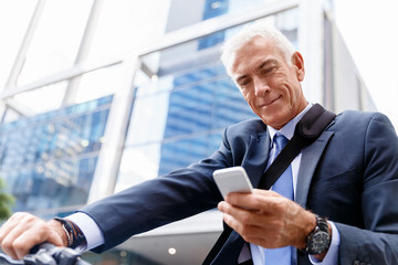 Successful businessman riding bicycle