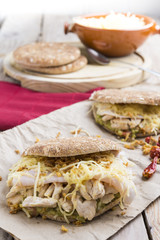 Sandwich with chickend and guacamole, cheese.