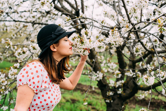 female in vintage clothes in cherry blossom