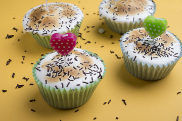 cupcake with a candle in the shape of a heart