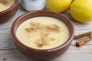 Traditional creme brulee on ceramic dish on wooden table
