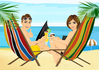 young couple sitting in deck chairs on the beach toasting