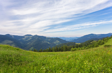Fototapeta premium Summer landscape in mountains and the dark blue sky with clouds