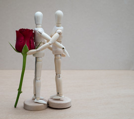 concept of love show by man Wood Figure hold rose give it to wom