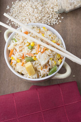 Rice with vegetables on white background