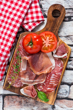 beautiful collection of sausages,ham,parma,salami, on rocks background.