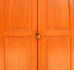 old rusty padlock  on white weathered wooden door
