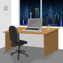 work desk interior with a laptop computer and window with night city scenery 