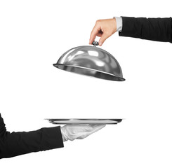 The hand of the waiter holding cloche over empty tray on an isol