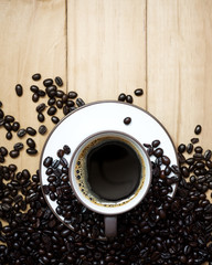 Coffee cup and coffee beans on a wood background., Flat lay.