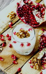 yogurt dessert with walnuts and pomegranate selective focus