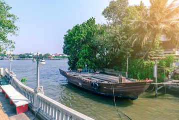 Plakat Old wooden boat at riverside harbour.