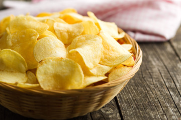 Crispy potato chips in a wicker bowl