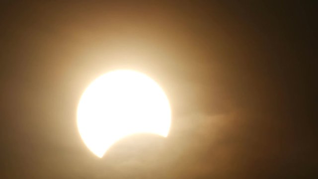 the nearly ending part of partly solar eclipse when sun rise in Thailand