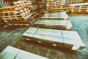Stacked pallets inside a warehouse. Industrial concept