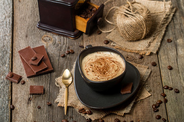 Cup of coffee with coffee beans and chocolate