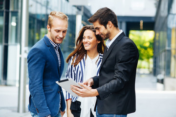Fototapeta premium Small group of business people looking at digital tablet 