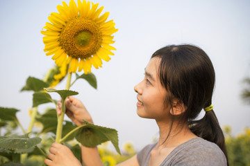 Woman summer girl happy in sunflower flower field.