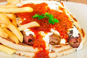 Grilled kebab under yogurt sauce and tomato, Greece Athens, national food, traditional Greek cuisine