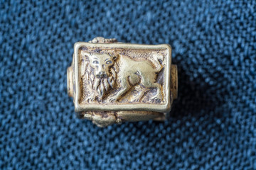Ancient rare animal carved golden beads Thai silk background