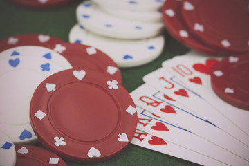 Poker chips and cards on a green table