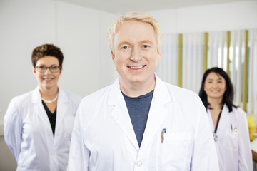 Fototapeta premium Confident Male Doctor Standing With Colleagues