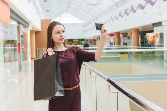 Girl taking a photo with her purchases