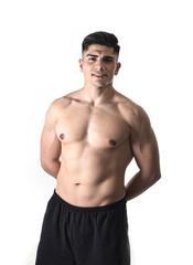 Fototapeta premium young handsome sport man posing with strong ripped naked torso looking cool and happy isolated on white
