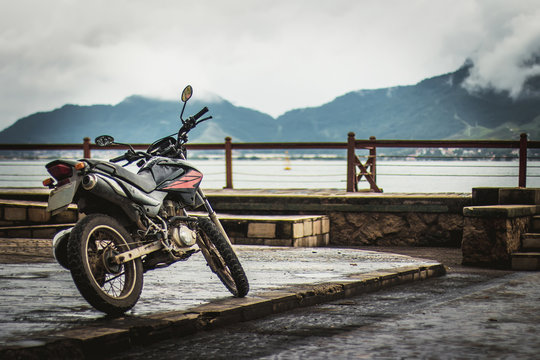 Motorbike at the raining bridge on the tropical iseland with a g