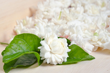 Jasmine flowers grouped on wooden board background