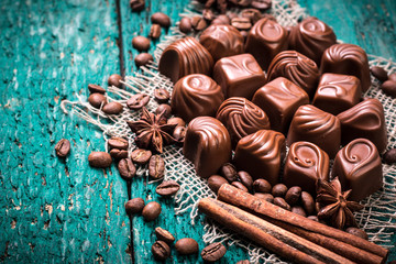 Delicious chocolate candies on wooden background