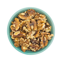 Bowl filled with shelled walnuts on a white background