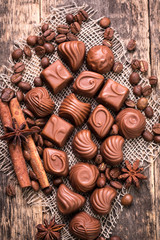 Delicious chocolate candies on wooden background