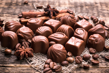 Delicious chocolate candies on wooden background