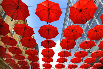 A lot of red umbrellas over the sky