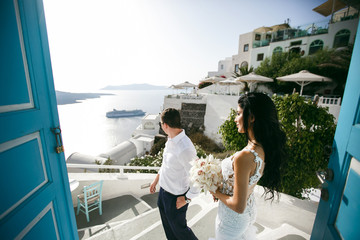 Fototapeta na wymiar Beautiful newlyweds in hotel on sea shore
