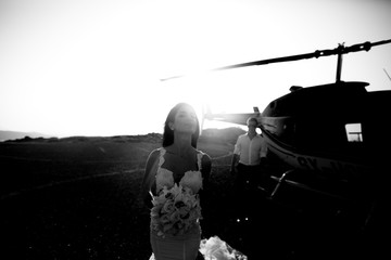 Happy beautiful newlyweds near the helicopter b&w © IVASHstudio