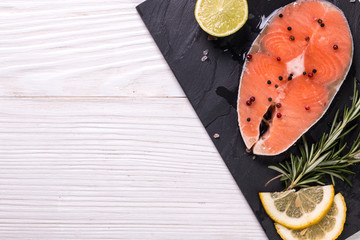 Raw salmon fillet and ingredients for cooking ,wooden background