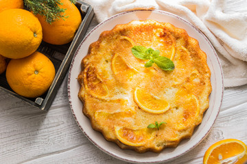 Orange cake, decorated with fresh mint (selective focus)